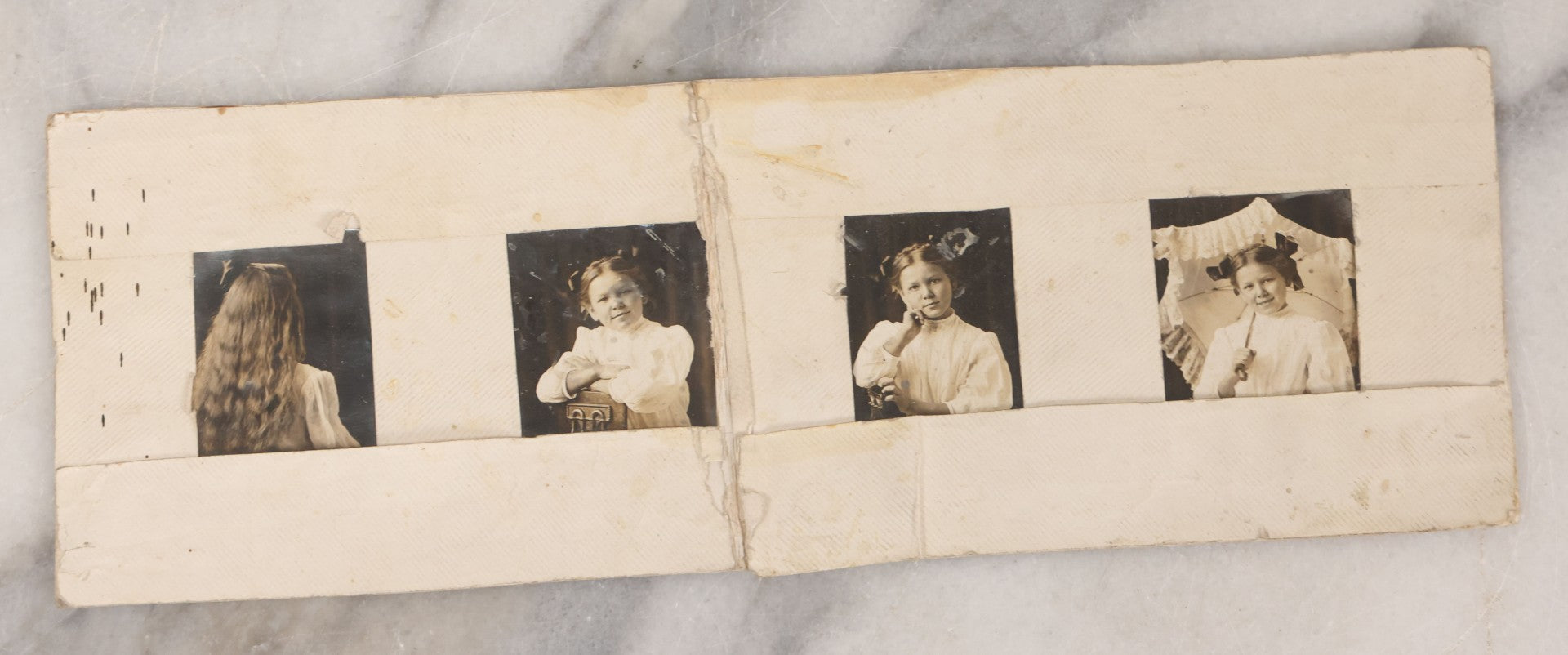 Lot 070 - Grouping Of Seven Antique Photographs Of Children, Including Makeshift Frame Of Girl In Four Views, Children Posing On New York City Stoop, Children In Cribs, Boy Posing With Toys