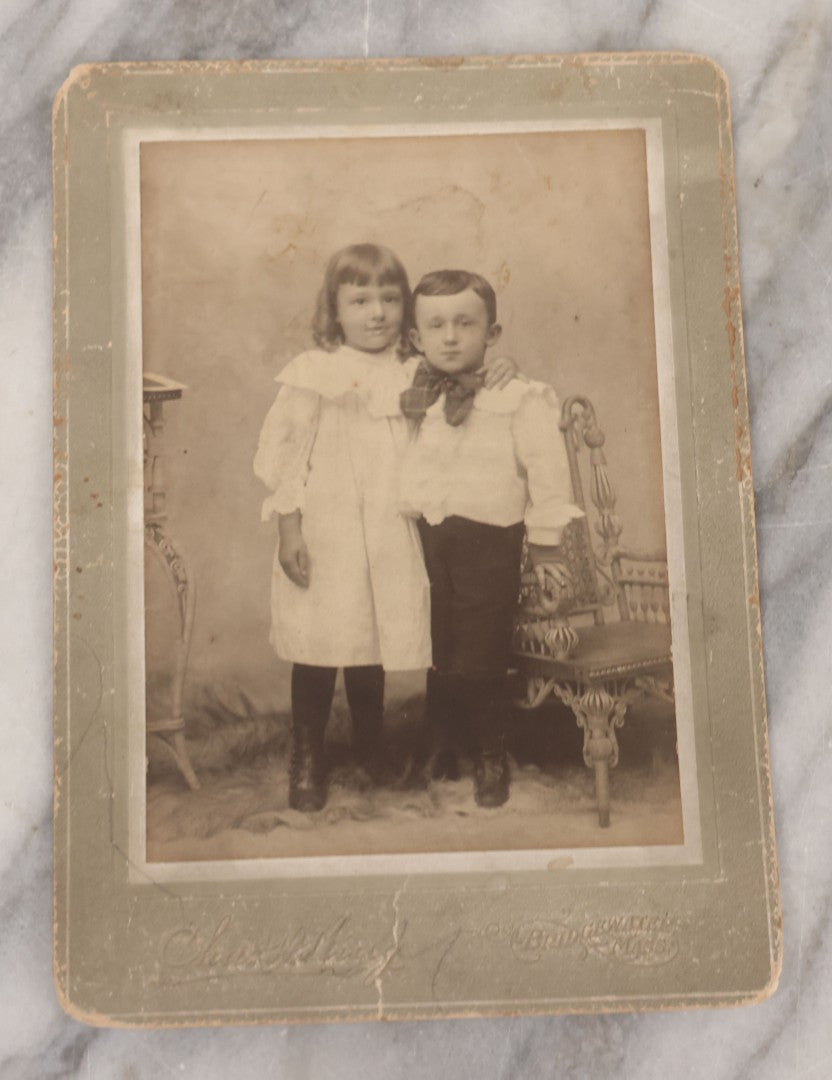 Lot 070 - Grouping Of Seven Antique Photographs Of Children, Including Makeshift Frame Of Girl In Four Views, Children Posing On New York City Stoop, Children In Cribs, Boy Posing With Toys