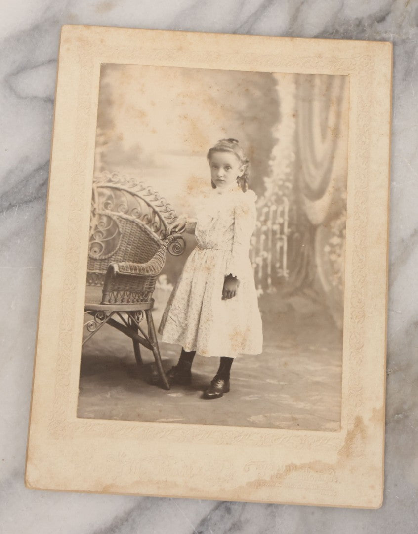 Lot 070 - Grouping Of Seven Antique Photographs Of Children, Including Makeshift Frame Of Girl In Four Views, Children Posing On New York City Stoop, Children In Cribs, Boy Posing With Toys