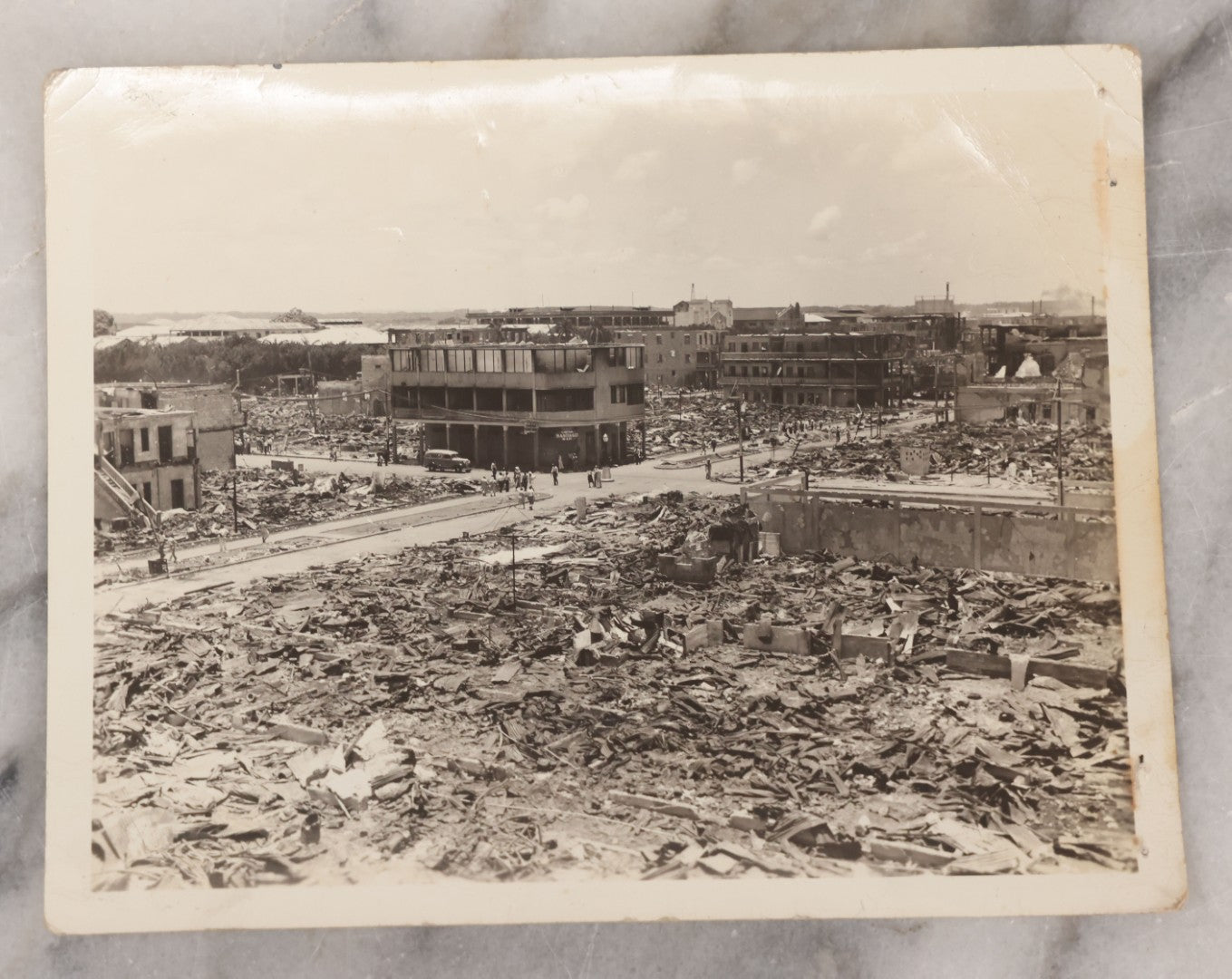 Lot 073 - Grouping Of Eight Vintage Snapshot Photographs, Including Photos Of Marching Soldiers, Barracks, Prison Ruins, And Fire Destruction