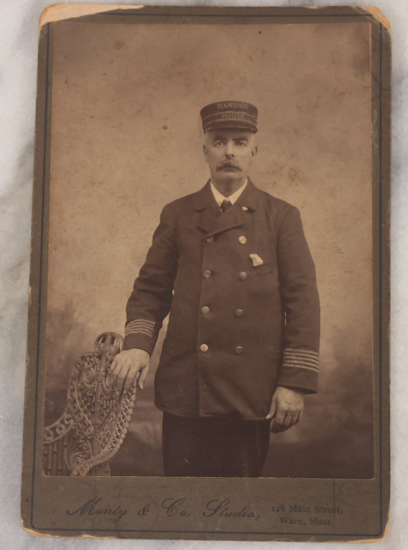 Lot 074 - Pair Of Duplicate Antique Cabinet Card Photographs Of "Mansion House" Worker In Uniform With Cap, Monty & Co. Studio, Photographers, Ware, Massachusetts