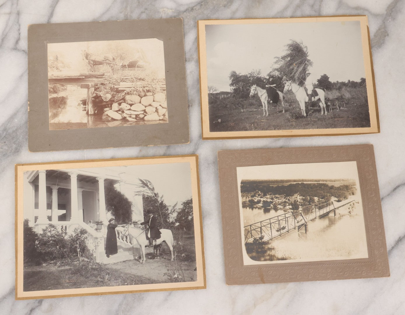 Lot 075 - Grouping Of Four Antique Boarded Photographs Of People And Horses, Including Horse Drawn Cart Crossing Primitive Bridge, Carriages Crossing Suspension Bridge, People On White Horses