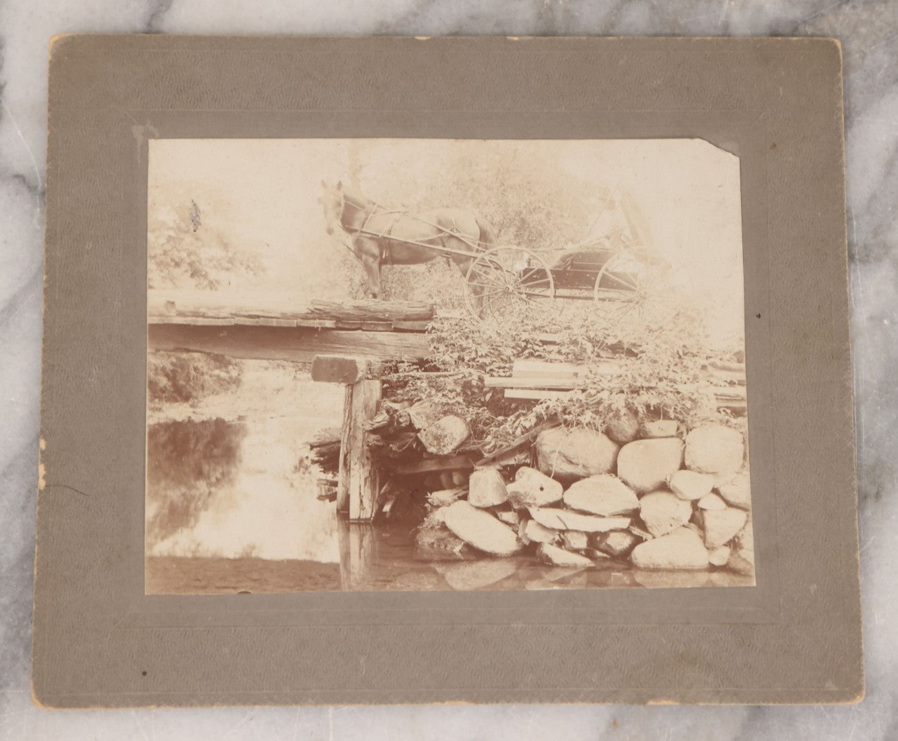 Lot 075 - Grouping Of Four Antique Boarded Photographs Of People And Horses, Including Horse Drawn Cart Crossing Primitive Bridge, Carriages Crossing Suspension Bridge, People On White Horses
