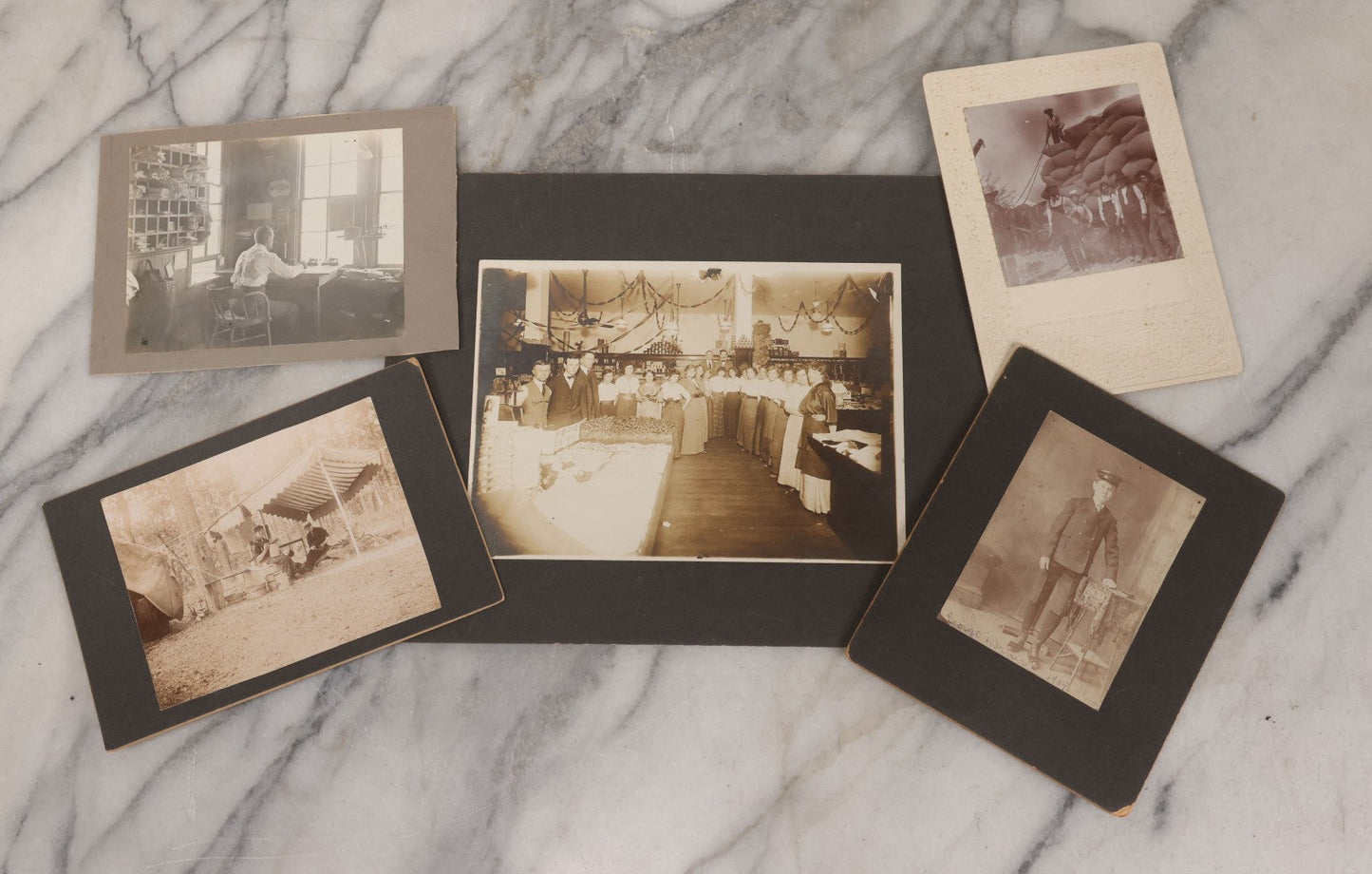 Lot 077 - Grouping Of Five Antique Boarded Occupational Photographs Including Bell Boy, Man At Desk, And Group Of Workers In General Store