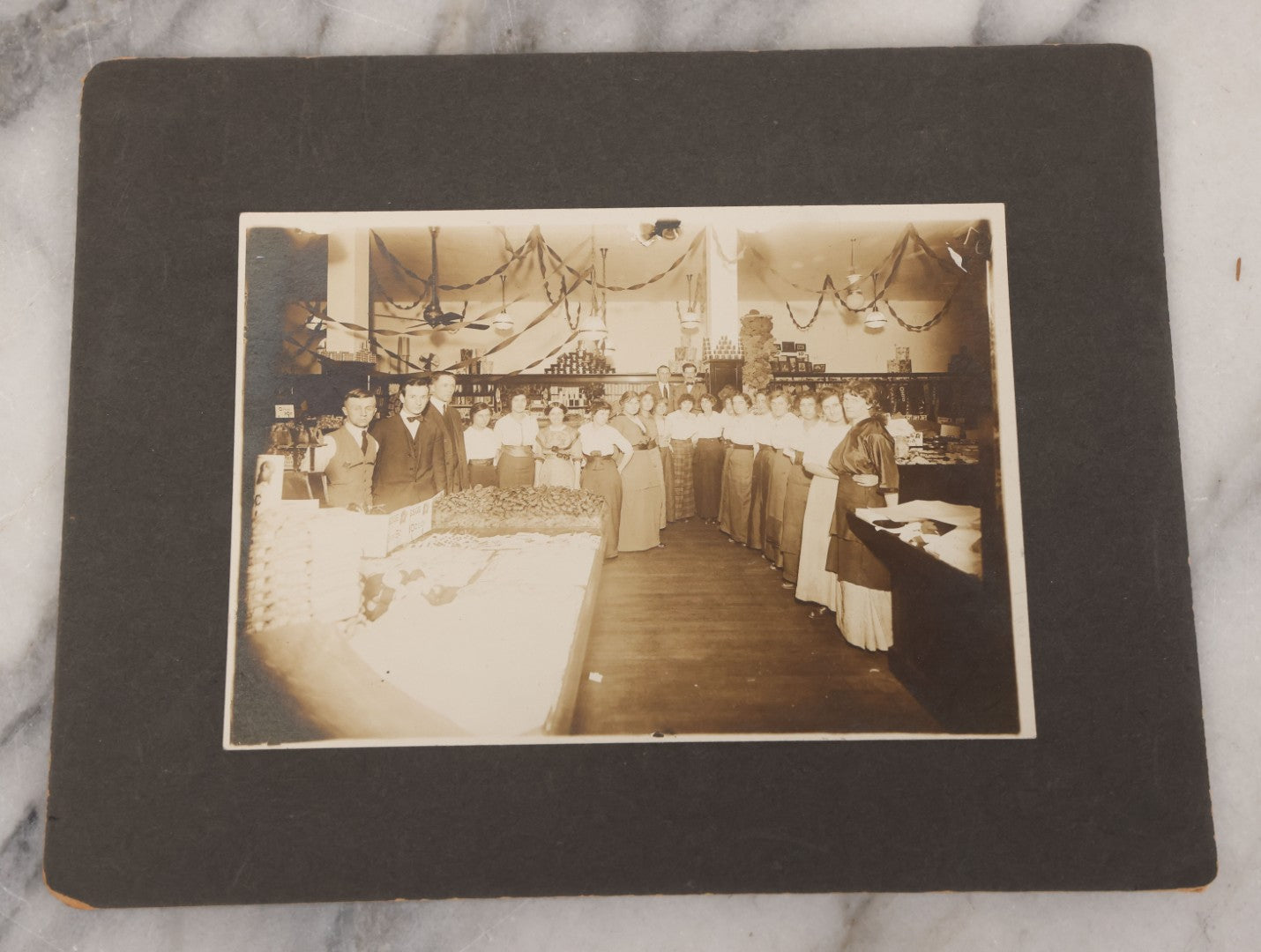 Lot 077 - Grouping Of Five Antique Boarded Occupational Photographs Including Bell Boy, Man At Desk, And Group Of Workers In General Store