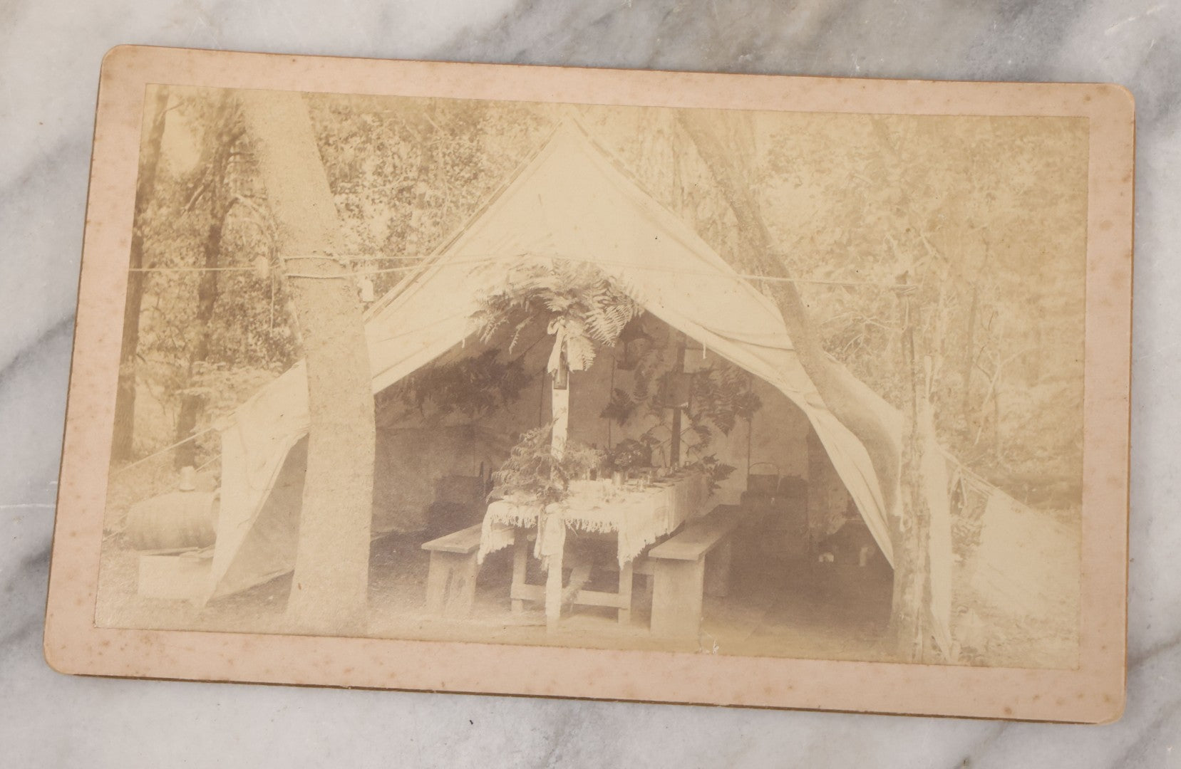 Lot 078 - Grouping Of Six Antique Boarded Outdoor Photographs Including Group In Car, Tent Decorated For Dinner Party, Couple Laughing In Tree, And Western Cabin