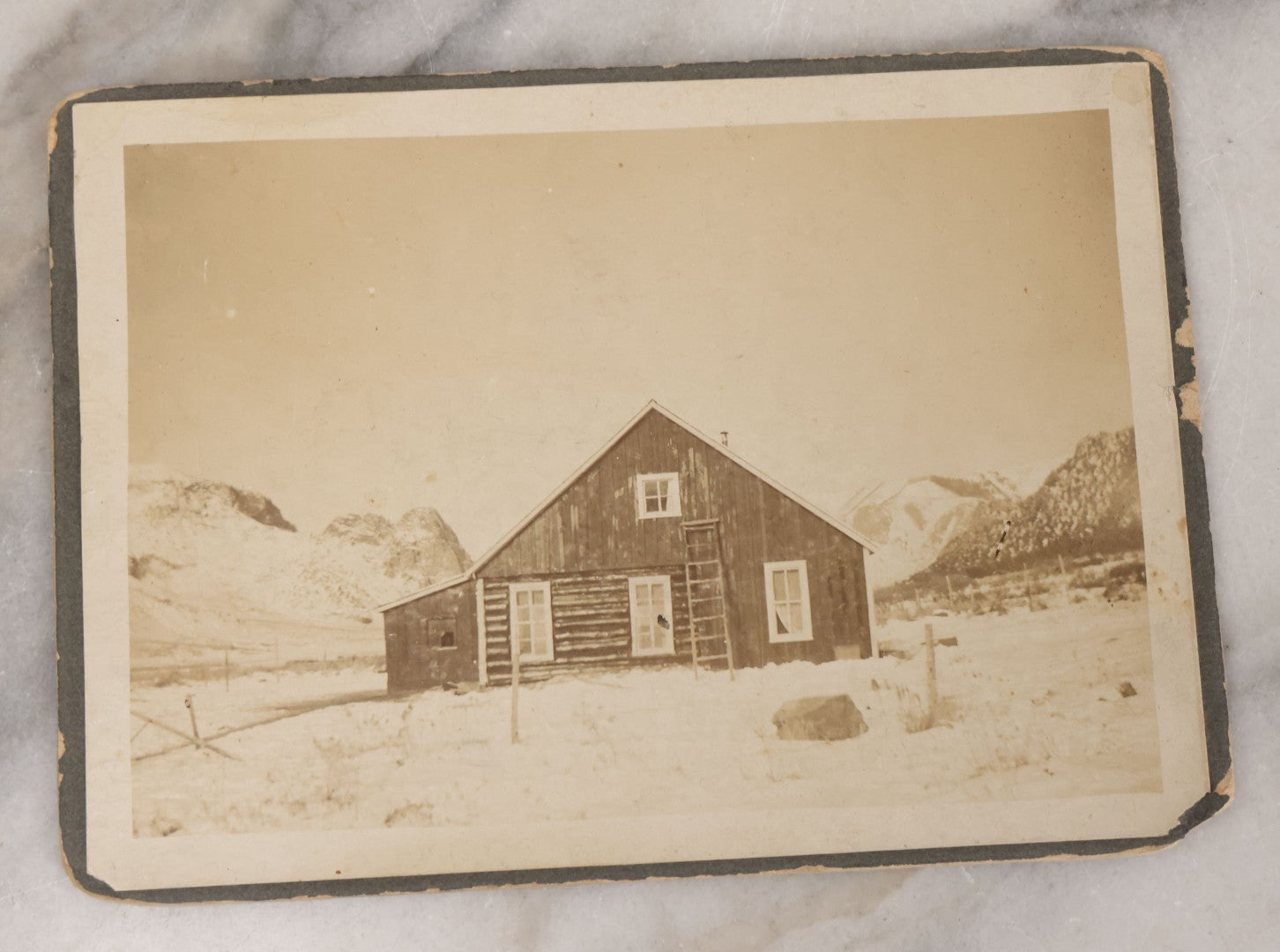 Lot 078 - Grouping Of Six Antique Boarded Outdoor Photographs Including Group In Car, Tent Decorated For Dinner Party, Couple Laughing In Tree, And Western Cabin