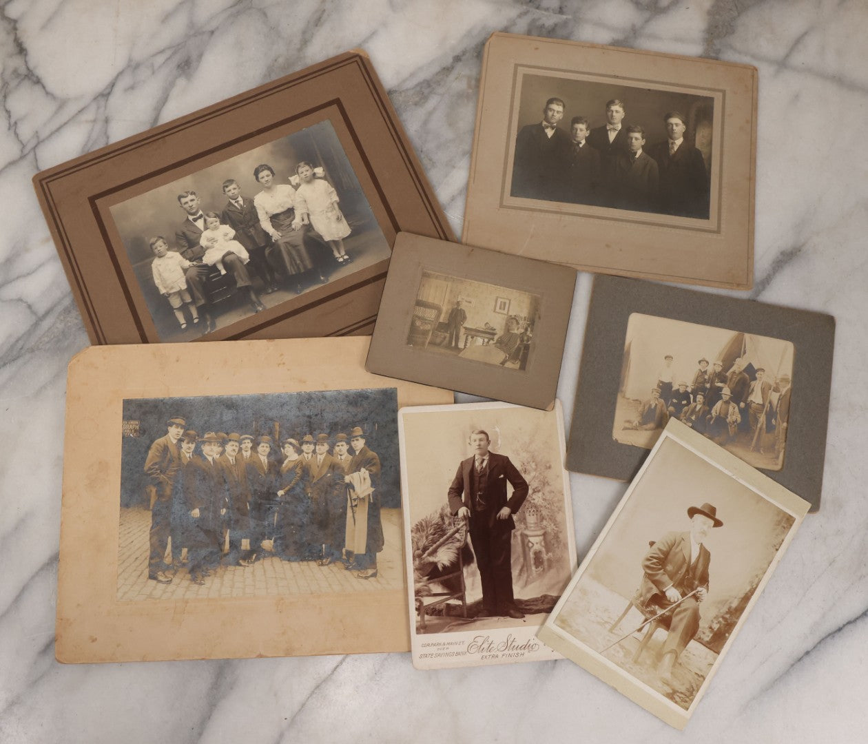 Lot 080 - Grouping Of Seven Antique Boarded Photographs Including Hunters Posing With Shotgun, Business Men In Bowler Hats, And Family Of Six
