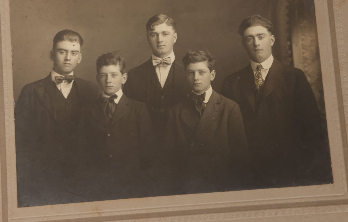 Lot 080 - Grouping Of Seven Antique Boarded Photographs Including Hunters Posing With Shotgun, Business Men In Bowler Hats, And Family Of Six