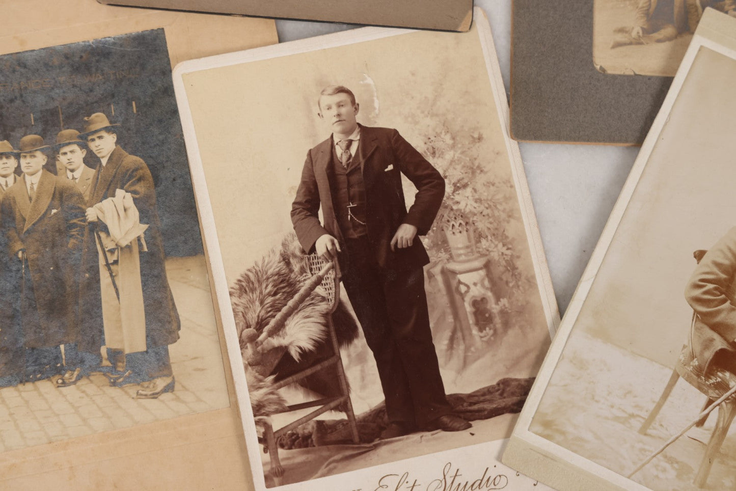Lot 080 - Grouping Of Seven Antique Boarded Photographs Including Hunters Posing With Shotgun, Business Men In Bowler Hats, And Family Of Six