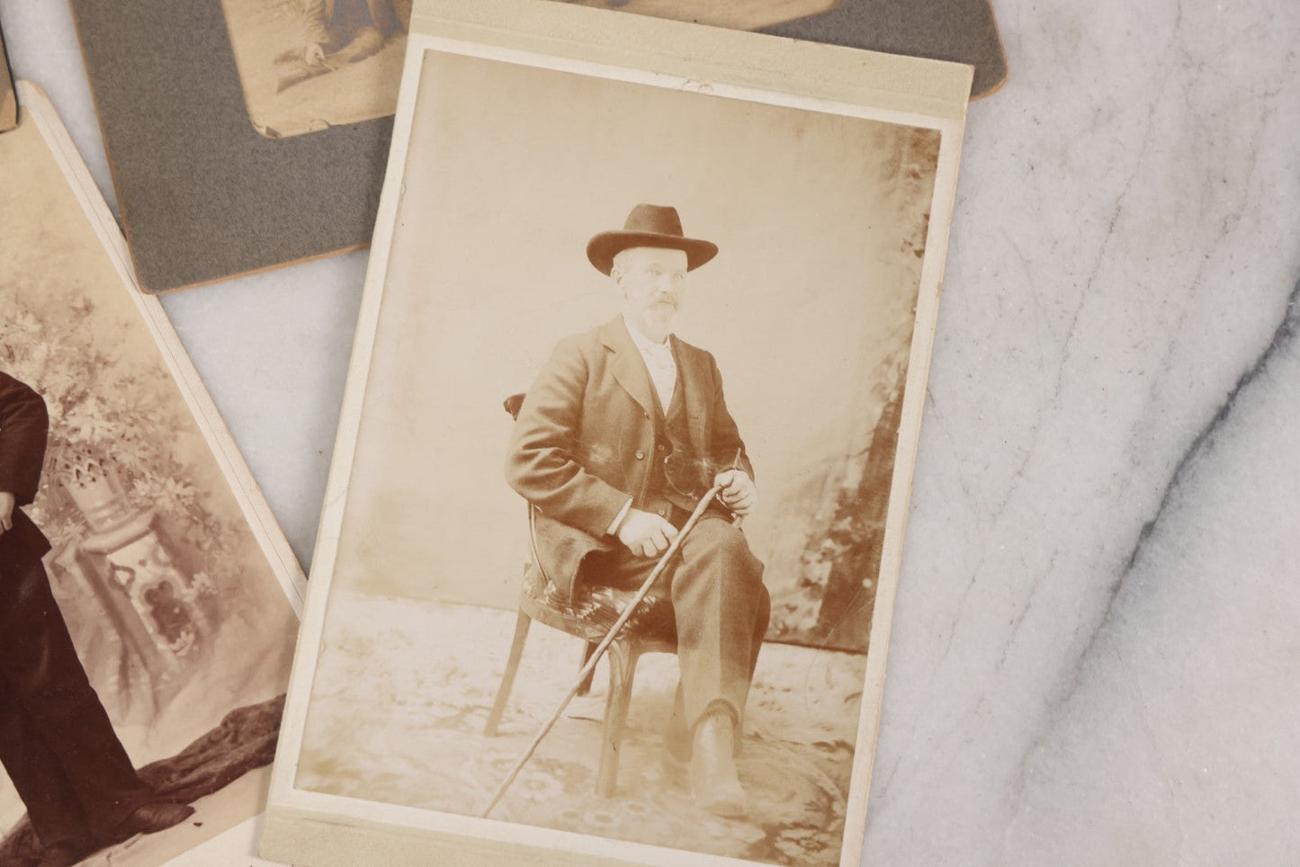 Lot 080 - Grouping Of Seven Antique Boarded Photographs Including Hunters Posing With Shotgun, Business Men In Bowler Hats, And Family Of Six