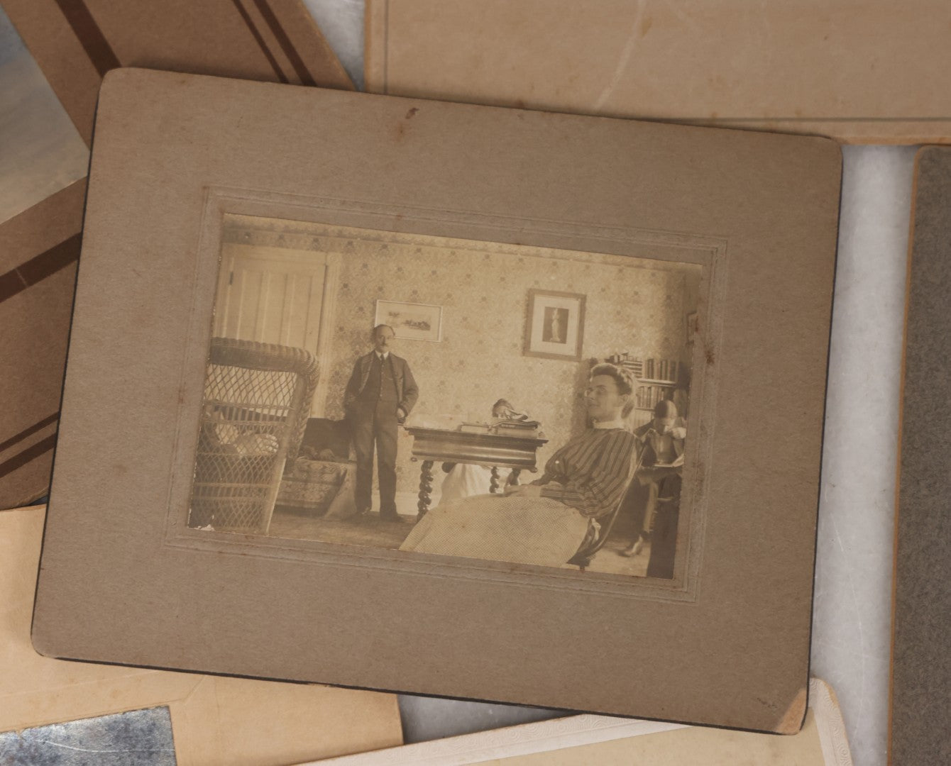 Lot 080 - Grouping Of Seven Antique Boarded Photographs Including Hunters Posing With Shotgun, Business Men In Bowler Hats, And Family Of Six