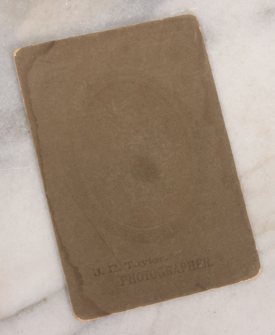 Lot 083 - Antique Boarded Photograph Of Two Young Men Enjoying Cigars, One Wearing A Knowing Smirk, J.E. Taylor, Photographer