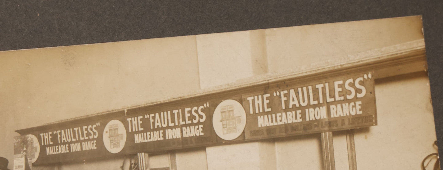 Lot 084 - Antique Boarded Occupational Photograph Of Three Men Inspecting A Large Variety Of Corn, With Advertisement For "The 'Faultless' Malleable Iron Range" In Background