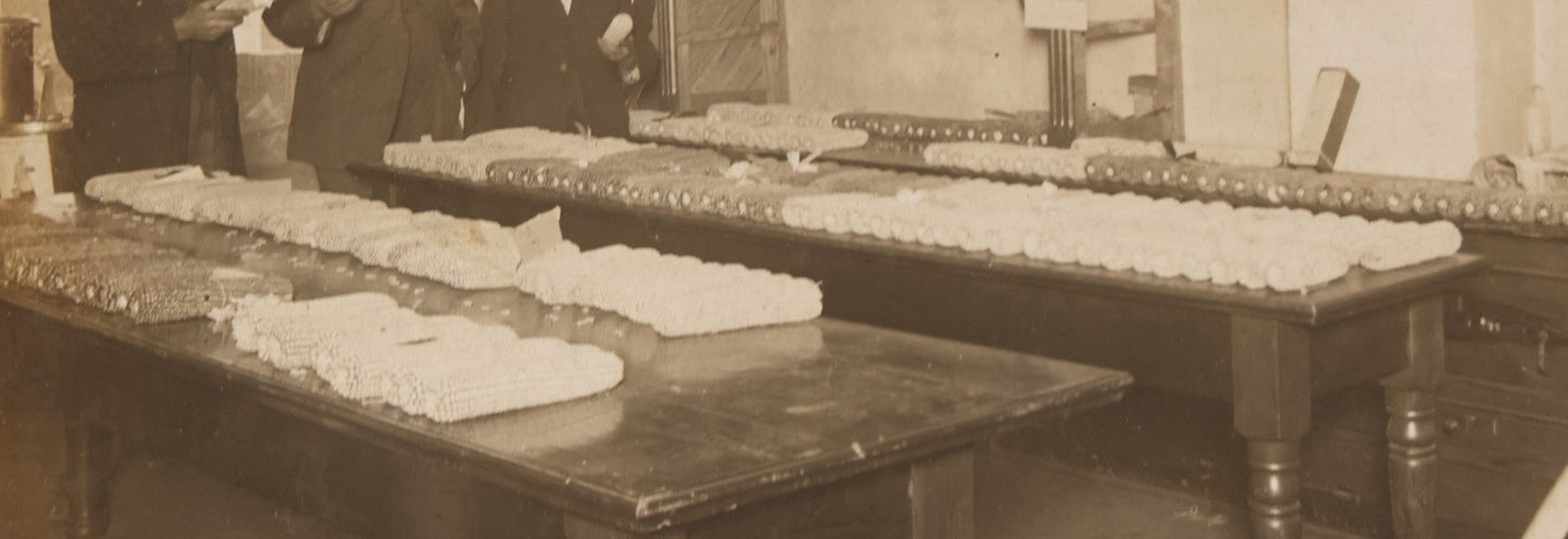 Lot 084 - Antique Boarded Occupational Photograph Of Three Men Inspecting A Large Variety Of Corn, With Advertisement For "The 'Faultless' Malleable Iron Range" In Background