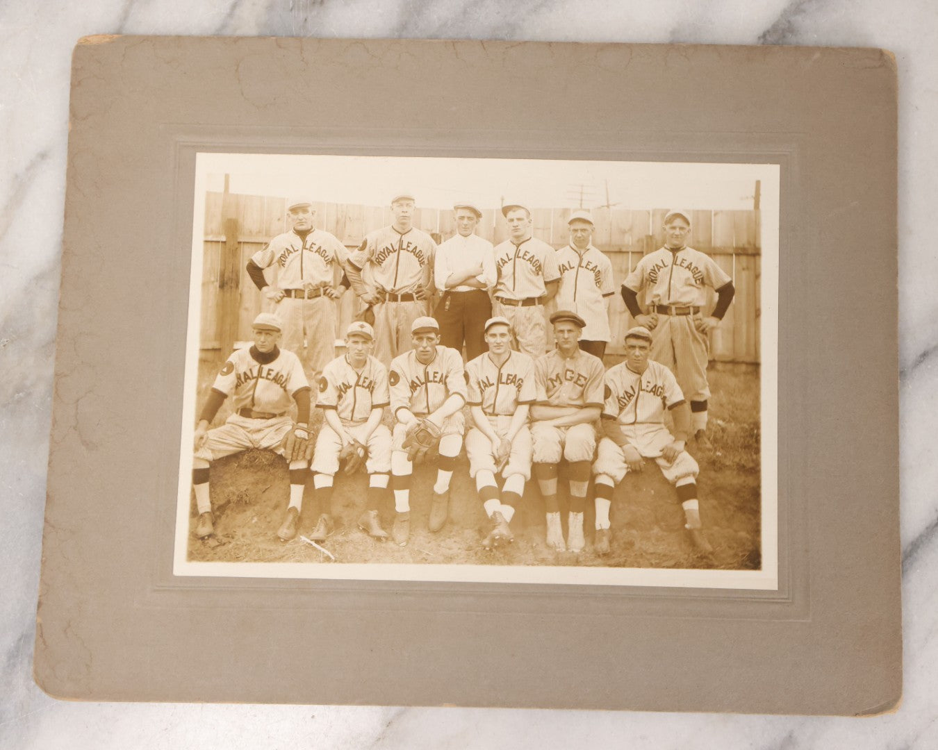Lot 087 - Antique Boarded Photograph Of Early Baseball Team Wearing "Royal League" Uniforms, Posing With Their Manager And A Man In Plain Clothes