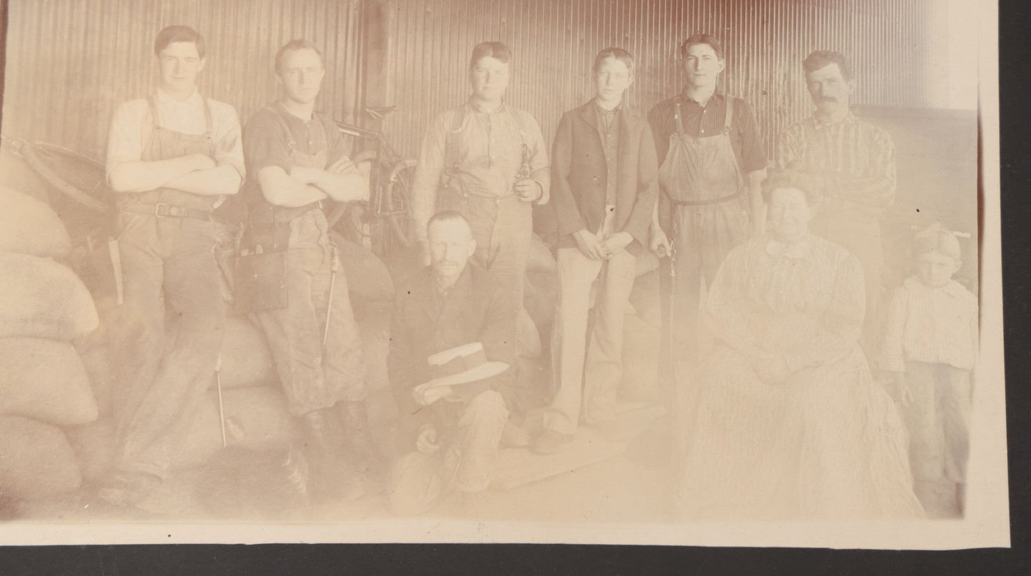 Lot 088 - Antique Boarded Occupational Photograph Of Group Of Workers, Unknown Trade, Posing On A Pile Of Sacks With Bicycles In Background