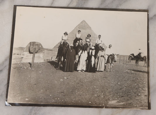 Lot 090 - Antique Unmounted Photograph Of Group Of Tourists On Camels Posing With Tour Guides In Front Of Great Pyramid Of Giza And Sphinx