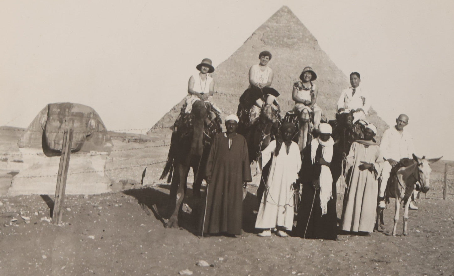 Lot 090 - Antique Unmounted Photograph Of Group Of Tourists On Camels Posing With Tour Guides In Front Of Great Pyramid Of Giza And Sphinx