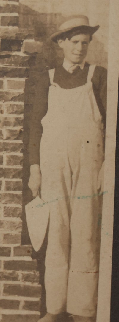 Lot 091 - Antique Boarded Photograph Of Two Young Bricklayers Posing With Tools In Front Of Newly Finished Fireplace With "W" Monogram