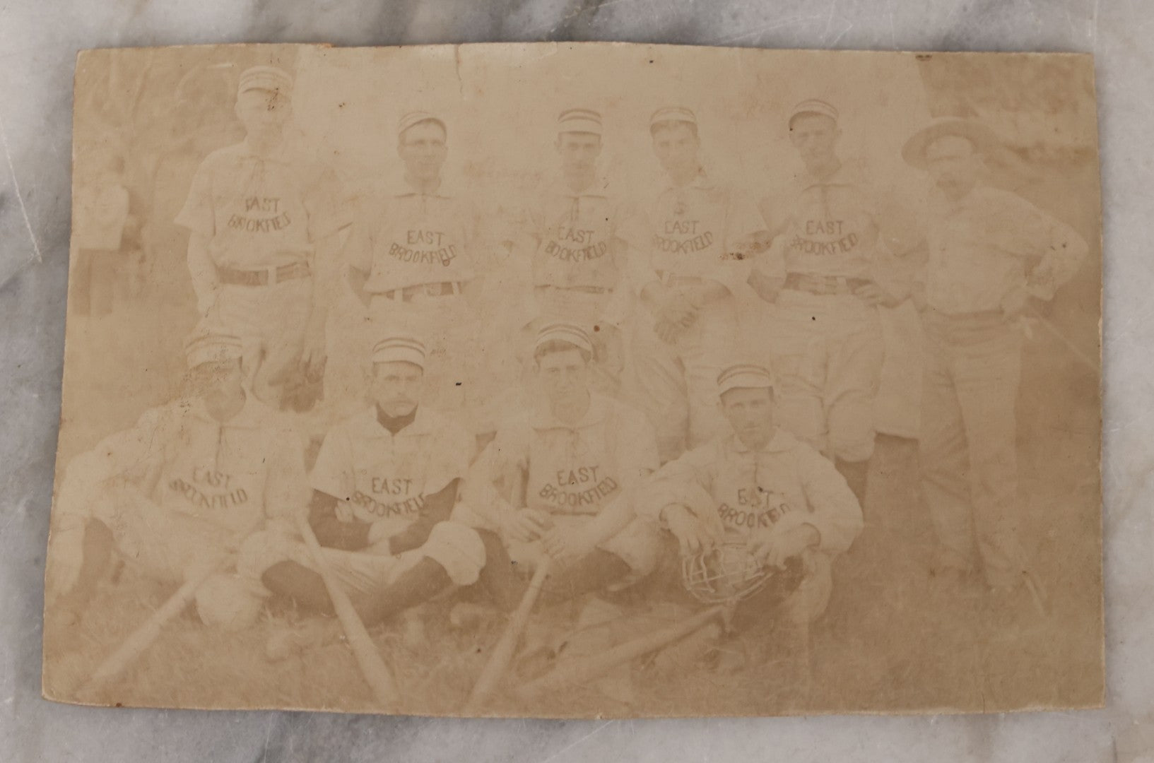 Lot 093 - Trimmed Antique Boarded Photograph Of Early Baseball Team From East Brookfield, Massachusetts, Posing With Bats And Equipment, B.L. Nichols, Photographer