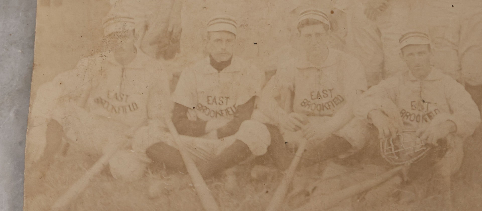 Lot 093 - Trimmed Antique Boarded Photograph Of Early Baseball Team From East Brookfield, Massachusetts, Posing With Bats And Equipment, B.L. Nichols, Photographer