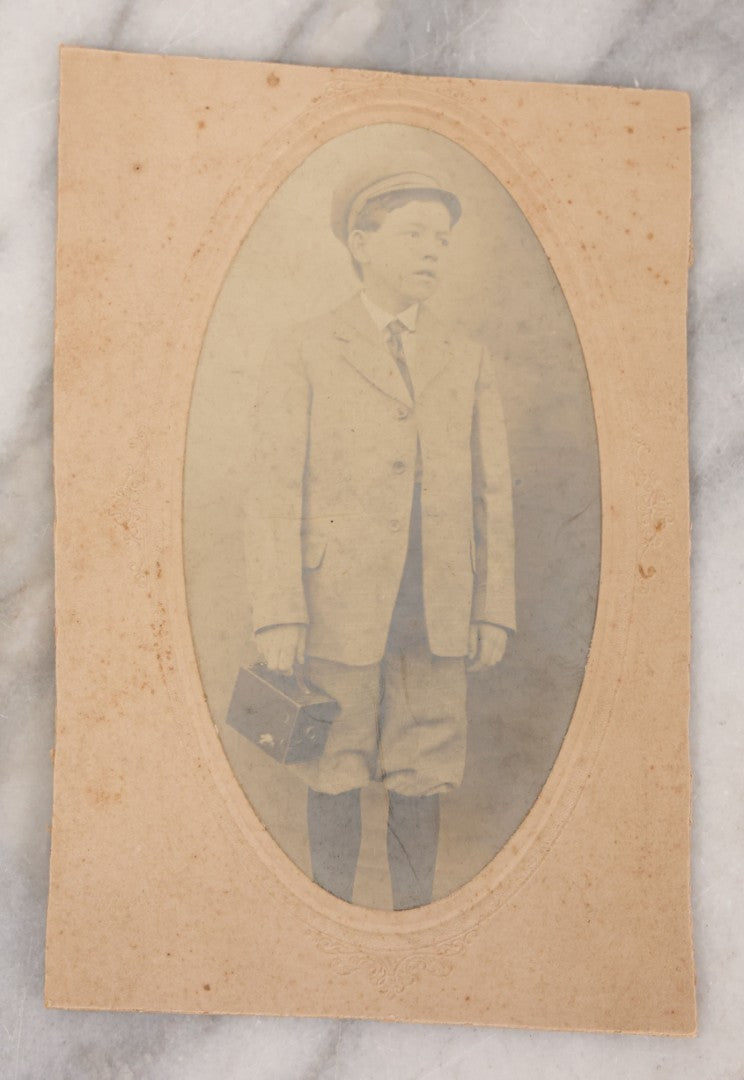 Lot 097 - Antique Trimmed Boarded Photograph Of Young Boy Photographer Posing With Turn Of The Century Box Camera