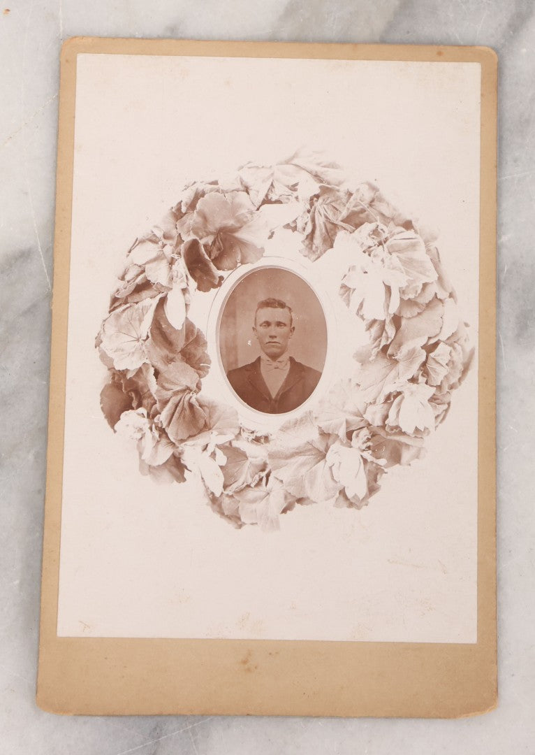 Lot 099 - Antique Cabinet Card Photograph Copy Of Tintype Of Man With Floral Wreath Surround, Likely A Remembrance Photograph