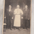 Lot 100 - Antique Trimmed Boarded Photograph Of Bartender Posing With Liquor Bottle, Glasses, And Cigar Box, With Two Men, Detailed Writing On Verso Likely In Polish