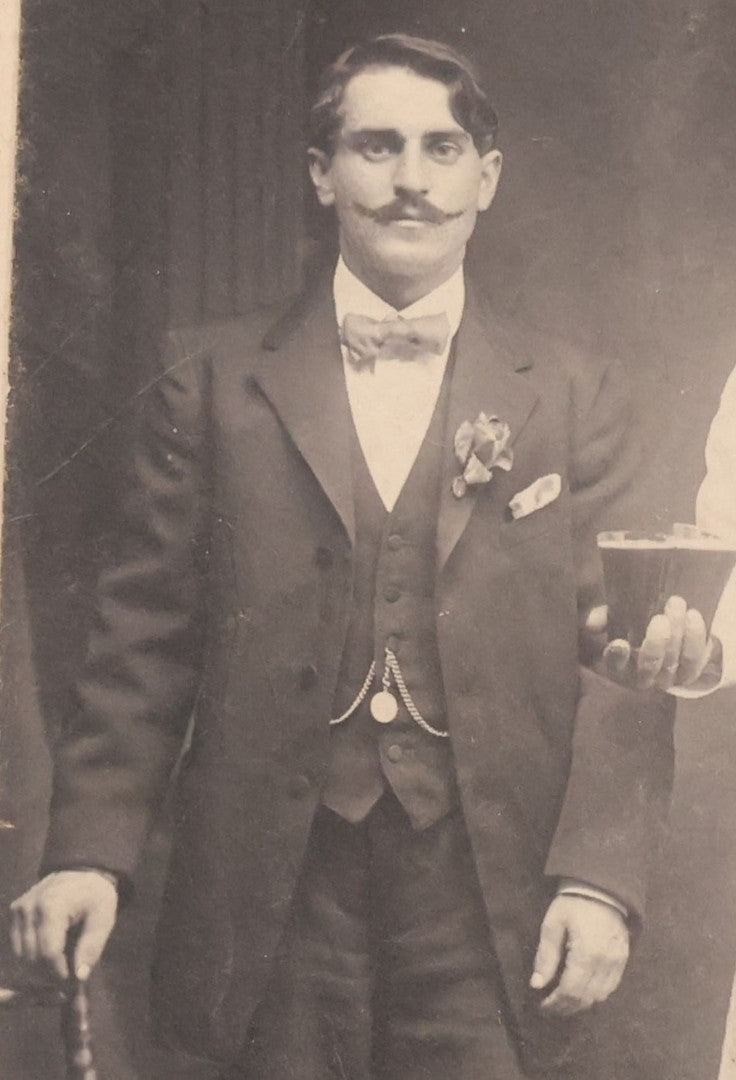 Lot 100 - Antique Trimmed Boarded Photograph Of Bartender Posing With Liquor Bottle, Glasses, And Cigar Box, With Two Men, Detailed Writing On Verso Likely In Polish