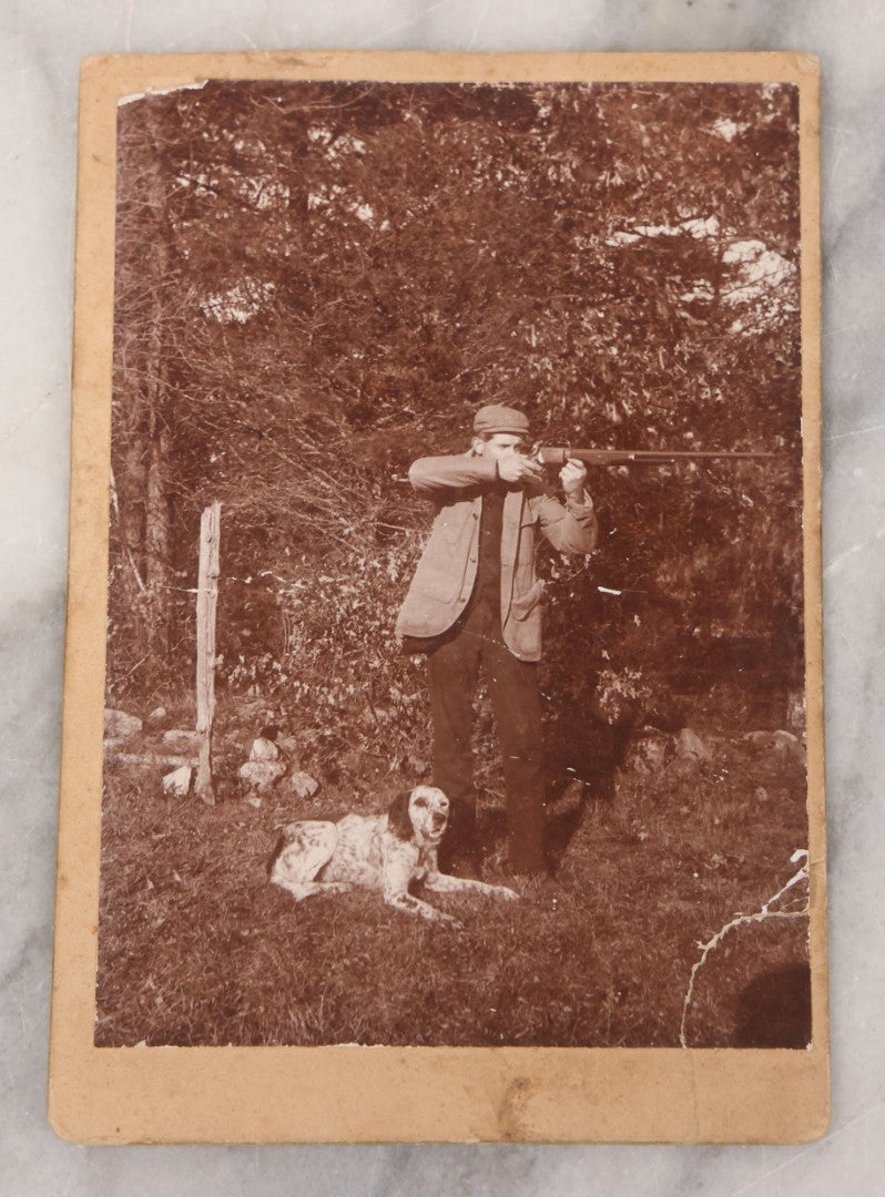 Lot 101 - Antique Cabinet Card Photograph Of Young Man Aiming A Shotgun Or Rifle With His Dog By His Feet, A.W. & G.E. Howes, Photographers, Ashfield, Massachusetts