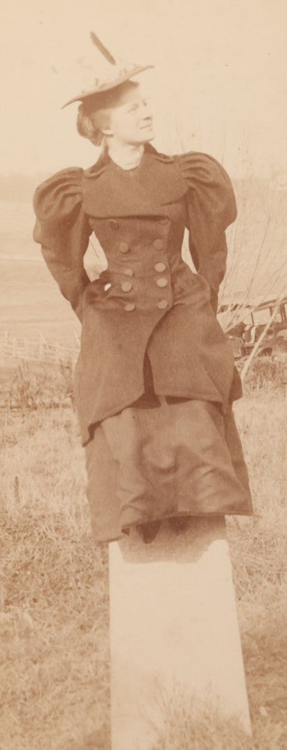 Lot 102 - Antique Boarded Photograph Of Woman In Peacoat Posing On Top Of Property Marker Pillar And Staring Fondly At The Sky, Farm In Background