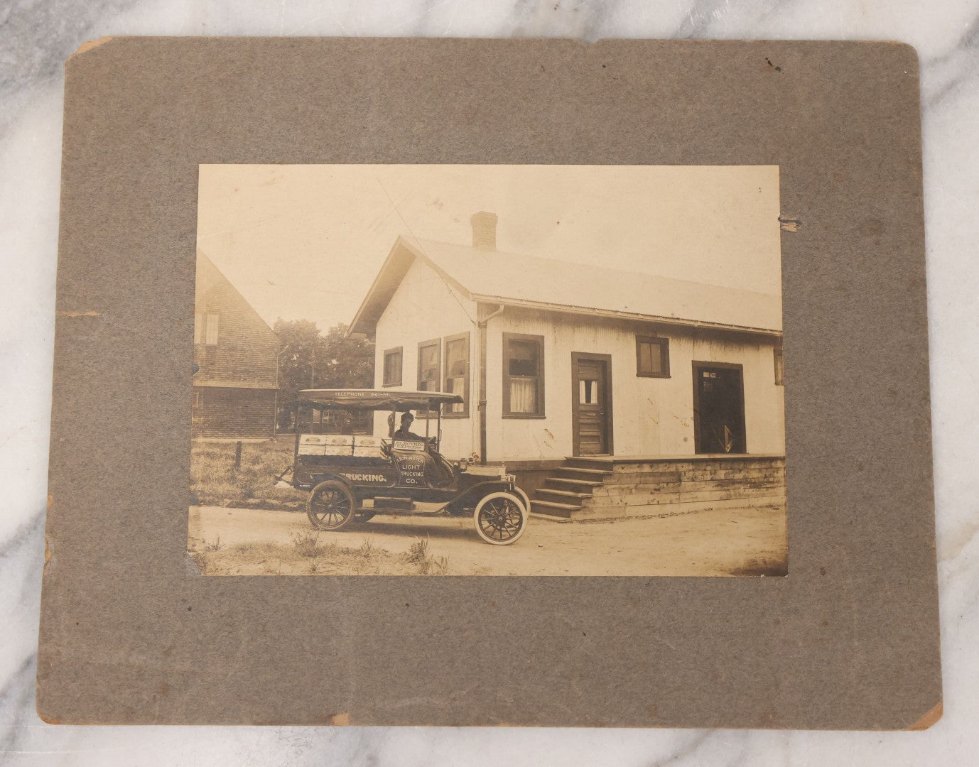 Lot 108 - Antique Boarded Occupational Photograph Of Man Driving An Early Automobile Delivery Truck For Leominster Light Trucking Co., Electric Express
