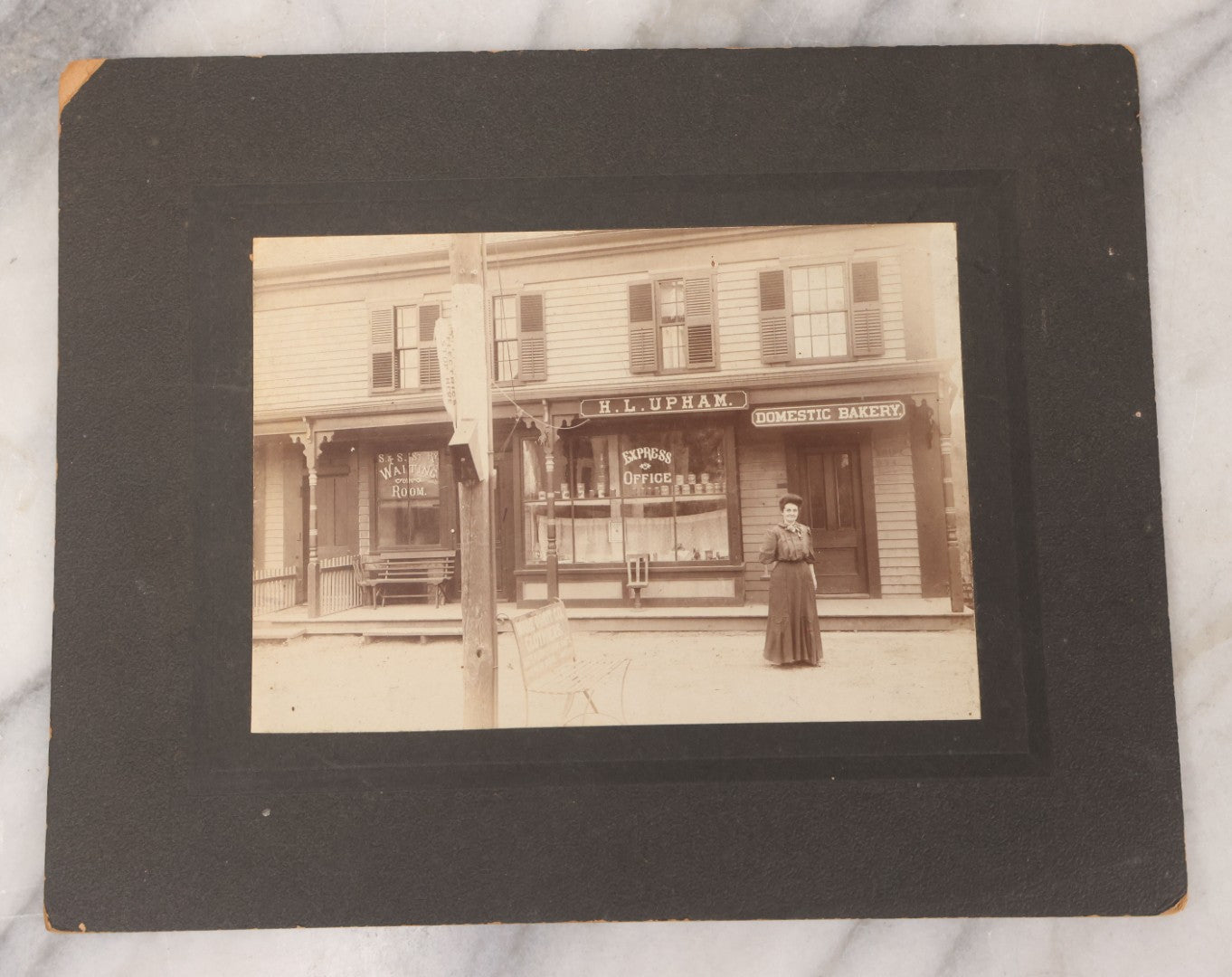 Lot 109 - Antique Boarded Occupational Photograph Of Proprietress Of H.L. Upham Domestic Bakery And Express Office Posing Outside Shop, Sturbridge, Massachusetts