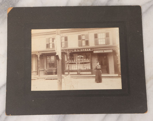 Lot 109 - Antique Boarded Occupational Photograph Of Proprietress Of H.L. Upham Domestic Bakery And Express Office Posing Outside Shop, Sturbridge, Massachusetts
