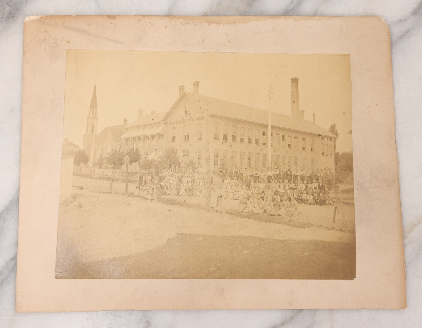 Lot 112 - Antique Boarded Occupational Photograph Of Large Group Of Workers Of The Dominion Button Works Factory, Ontario, Canada