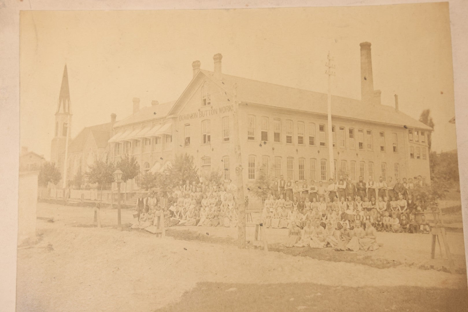 Lot 112 - Antique Boarded Occupational Photograph Of Large Group Of Workers Of The Dominion Button Works Factory, Ontario, Canada