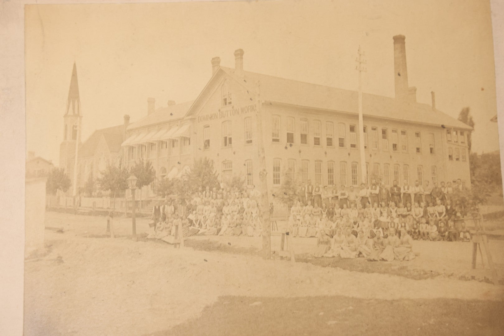 Lot 112 - Antique Boarded Occupational Photograph Of Large Group Of Workers Of The Dominion Button Works Factory, Ontario, Canada