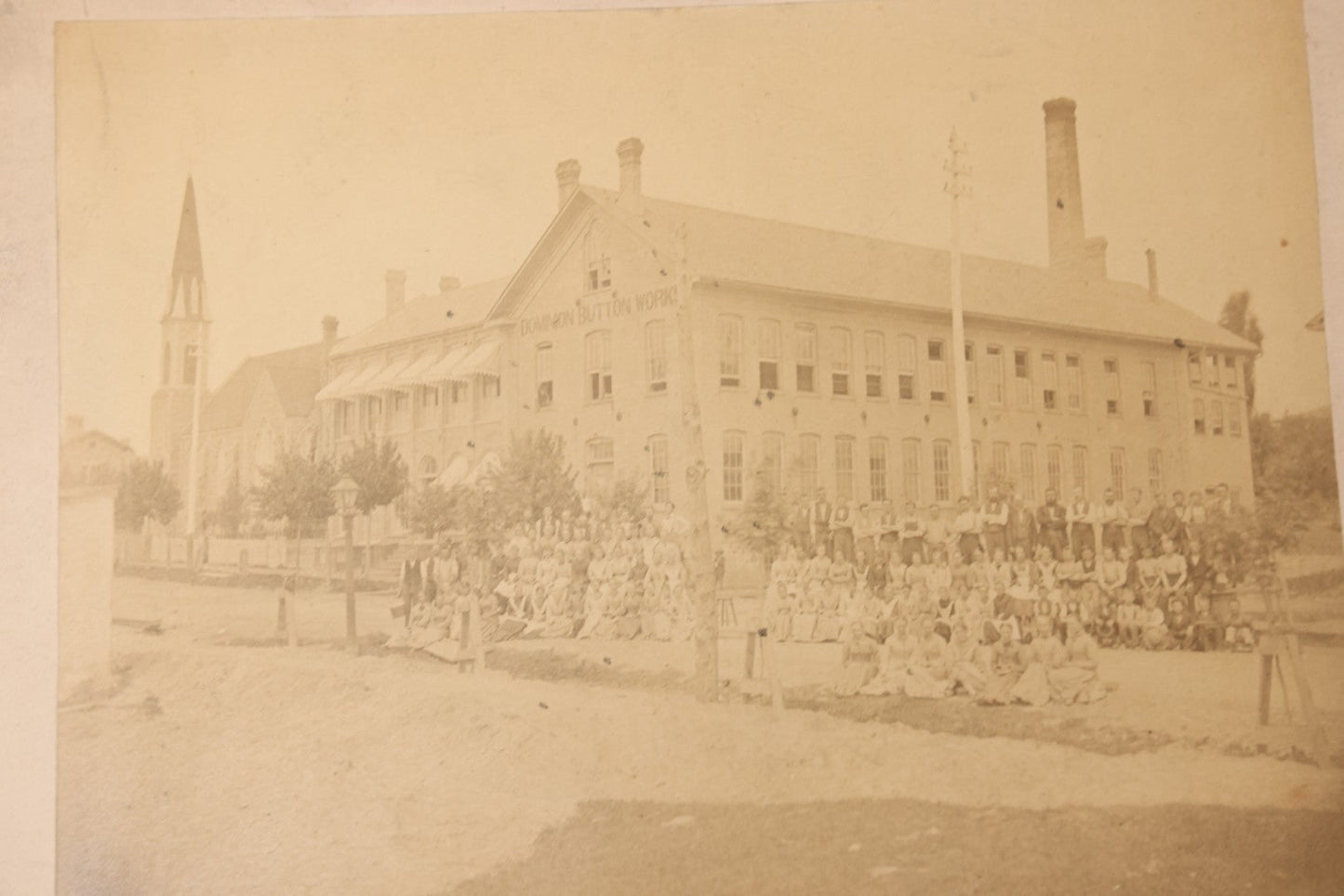 Lot 112 - Antique Boarded Occupational Photograph Of Large Group Of Workers Of The Dominion Button Works Factory, Ontario, Canada