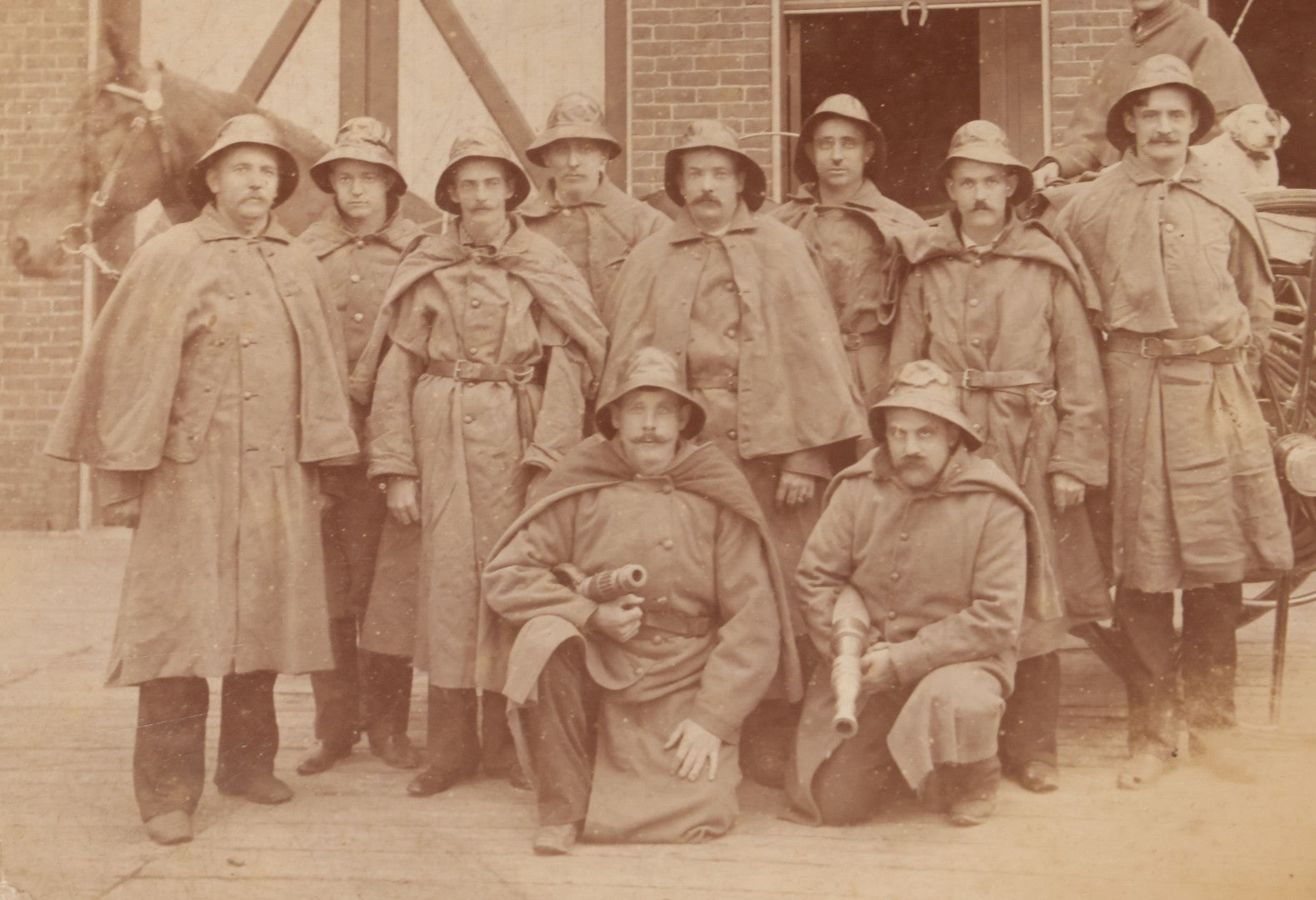 Lot 115 - Antique Boarded Occupational Photograph Of Group Of Late 19th Century Firefighters Posing With Their Horse Drawn Fire Engine And Their Firehouse Dog In Full Gear Outside Of Firehouse