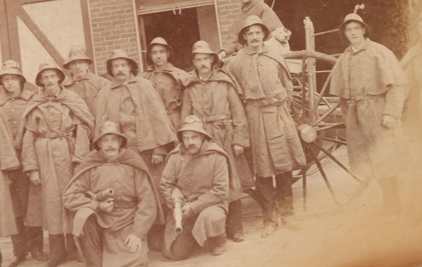 Lot 115 - Antique Boarded Occupational Photograph Of Group Of Late 19th Century Firefighters Posing With Their Horse Drawn Fire Engine And Their Firehouse Dog In Full Gear Outside Of Firehouse