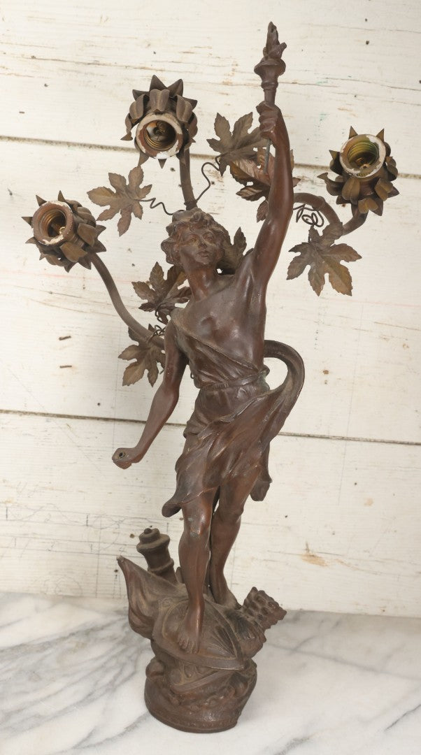 Lot 001 - Antique French Bronzed Spelter Art Nouveau Neo-Classical Revival Figural Lamp Base With Male Figure With Outstretched Arm Holding Torch And Three Curved Lighting Arms With Metal Leaves, Note Lamp Needs Complete Rewiring And Has Metal Damage