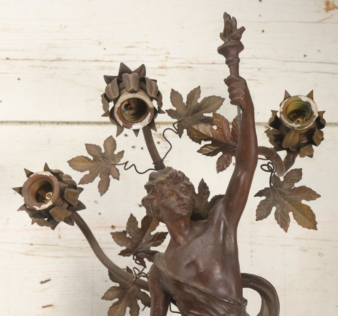 Lot 001 - Antique French Bronzed Spelter Art Nouveau Neo-Classical Revival Figural Lamp Base With Male Figure With Outstretched Arm Holding Torch And Three Curved Lighting Arms With Metal Leaves, Note Lamp Needs Complete Rewiring And Has Metal Damage