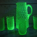 Lot 014 - Vintage Six Piece Hobnail Uranium Glass Drinking Collection With Pitcher And Four Matching Cups Plus Additional Cup, U.V. Blacklight Reactive Glass, Note Chips And Cracks