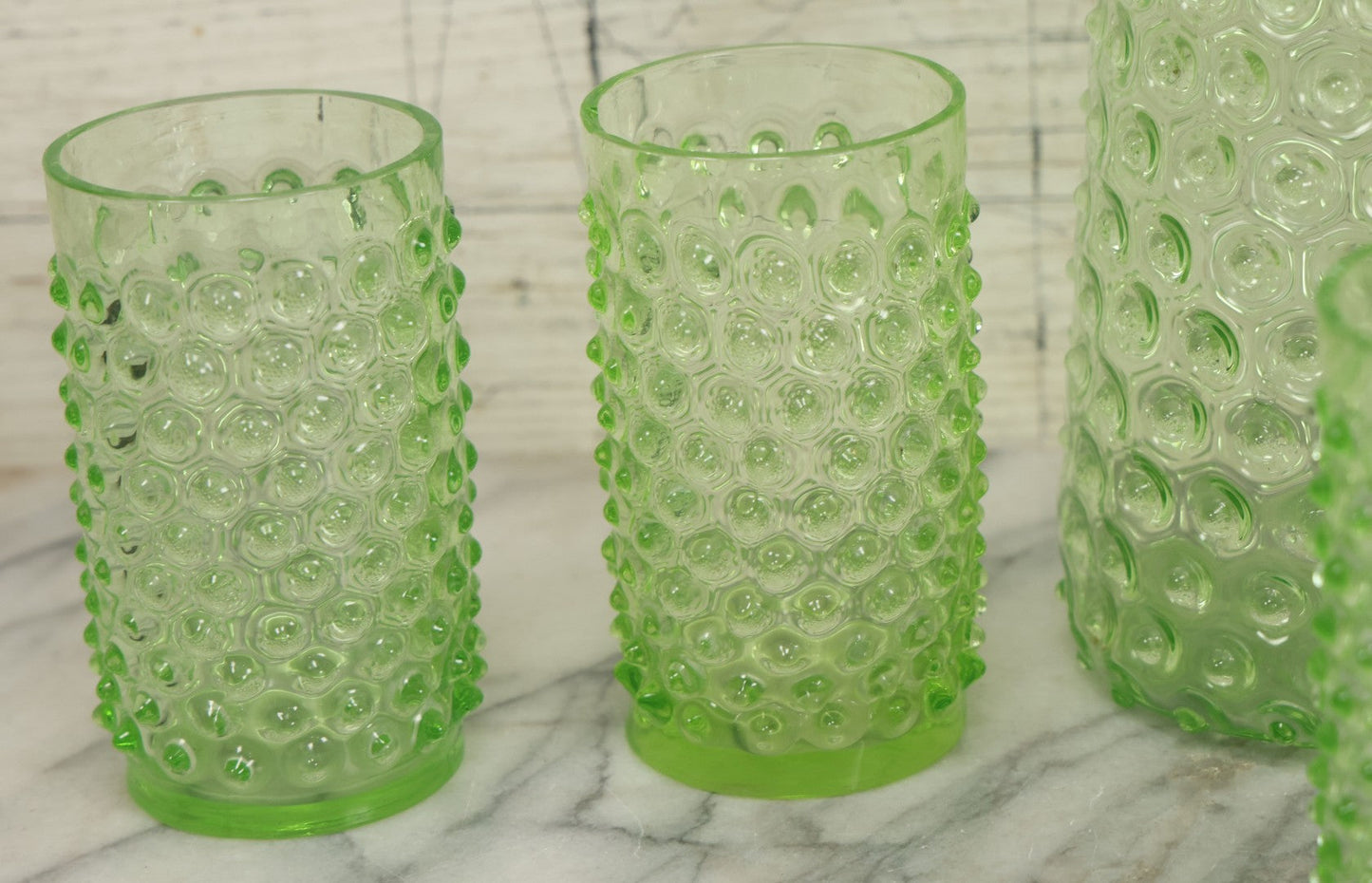 Lot 014 - Vintage Six Piece Hobnail Uranium Glass Drinking Collection With Pitcher And Four Matching Cups Plus Additional Cup, U.V. Blacklight Reactive Glass, Note Chips And Cracks