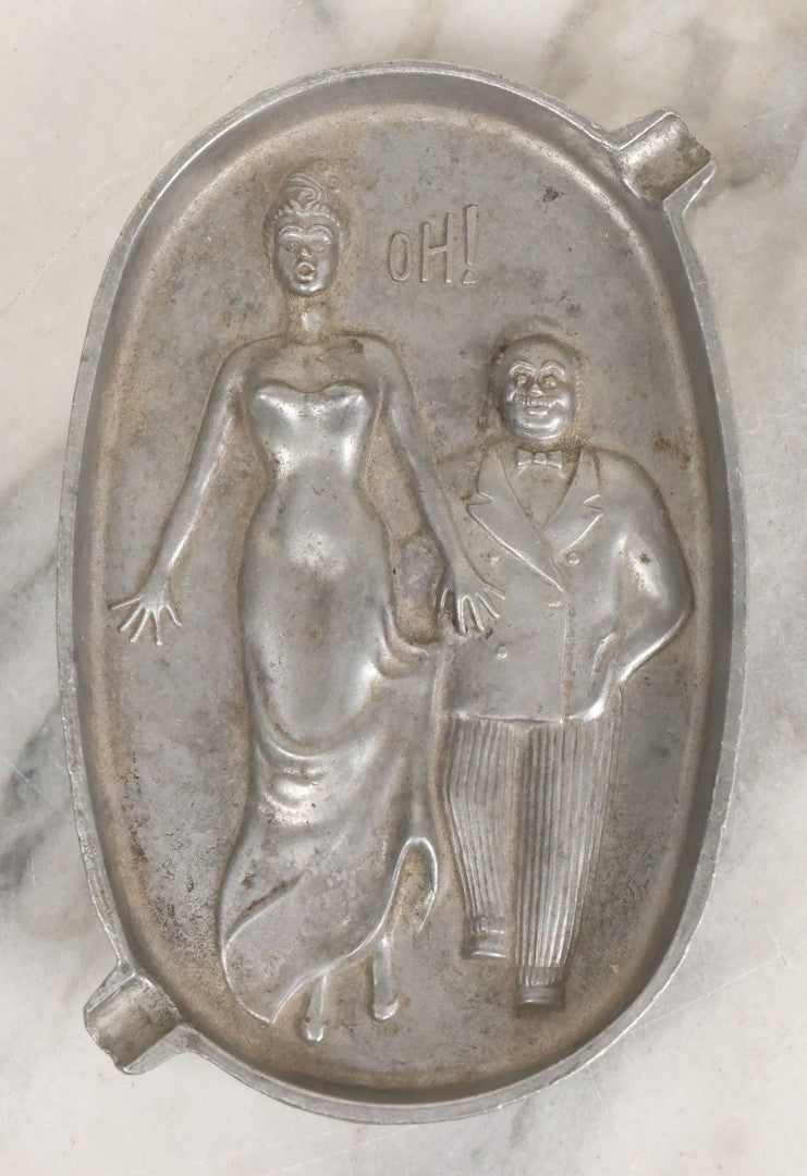 Lot 024 - Vintage Cast Aluminum "Oh! Ah!" Risqué Ashtray With Little Man Grabbing A Surprised Lady's Behind