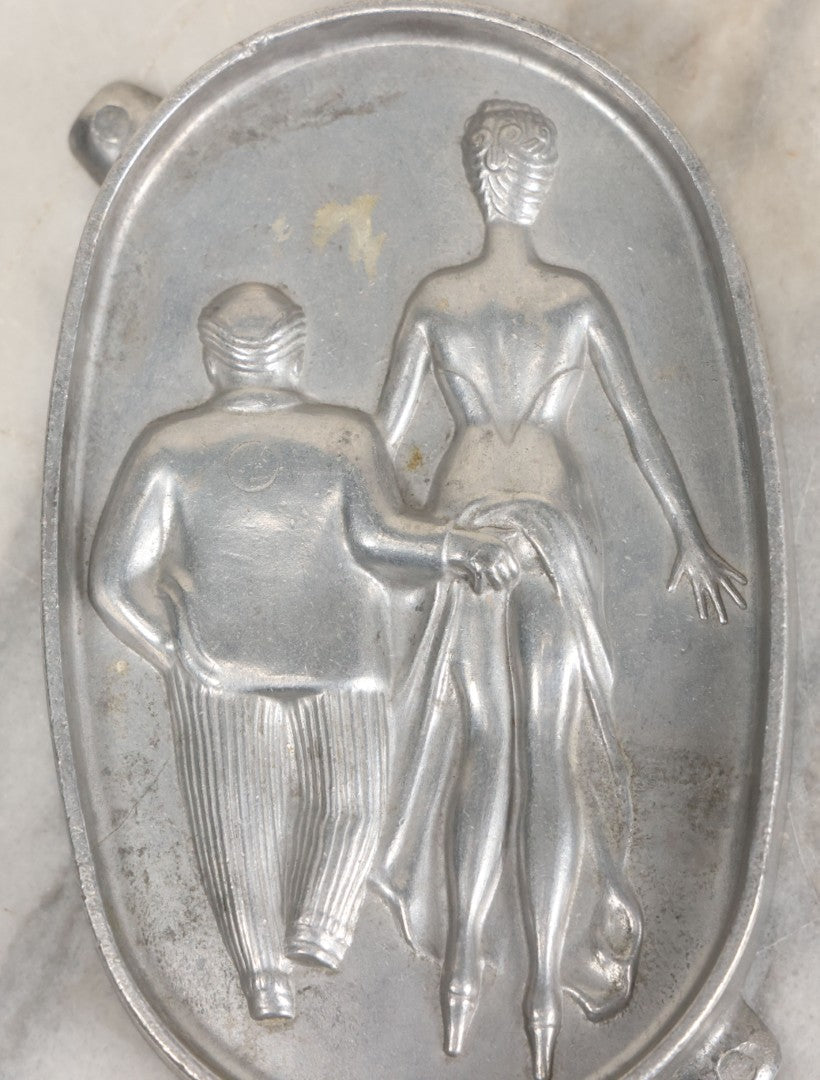 Lot 024 - Vintage Cast Aluminum "Oh! Ah!" Risqué Ashtray With Little Man Grabbing A Surprised Lady's Behind