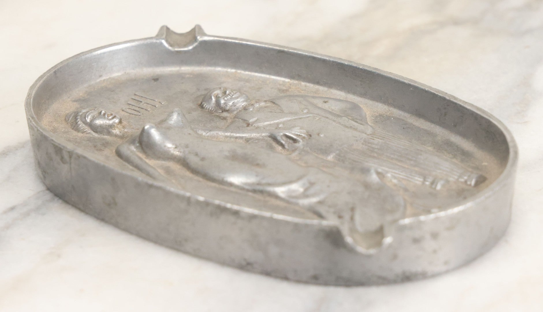 Lot 024 - Vintage Cast Aluminum "Oh! Ah!" Risqué Ashtray With Little Man Grabbing A Surprised Lady's Behind