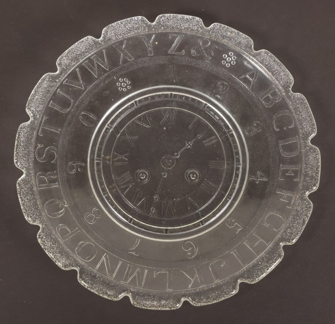 Lot 027 - Antique Early American Pattern Glass E.A.P.G. Alphabet Plate With Clock Motif, 7" Diameter