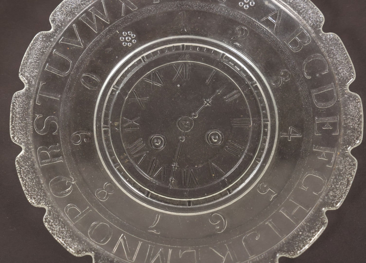 Lot 027 - Antique Early American Pattern Glass E.A.P.G. Alphabet Plate With Clock Motif, 7" Diameter